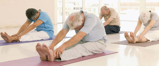 Adultos mayores haciendo pilates para tener una vida fitness.