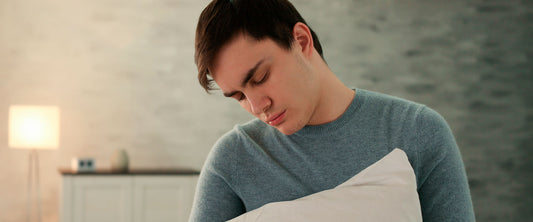 Hombre con sonambulismo sujetando una almohada.