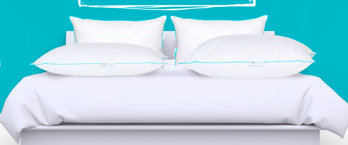 Imagen de una cama con Almohadas Sognare encima.