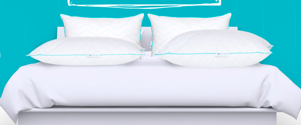 Imagen de una cama con Almohadas Sognare encima.